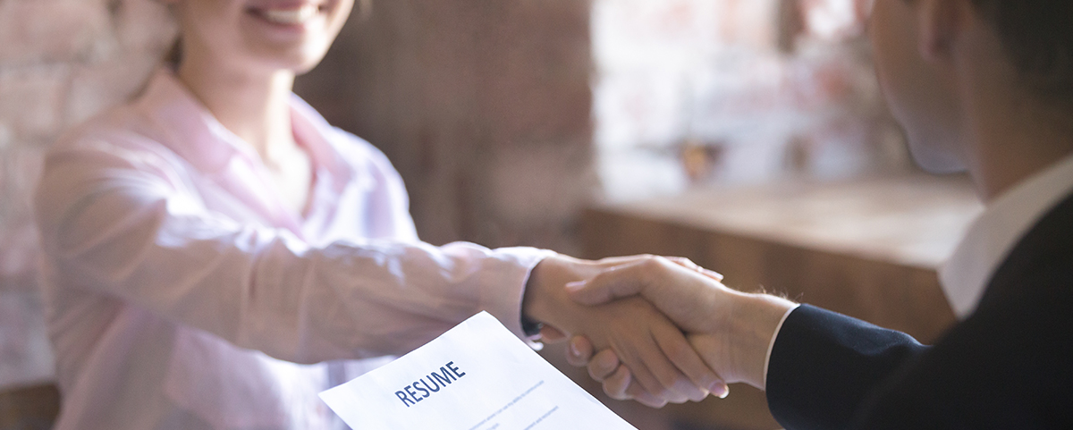 woman shaking hand with resume