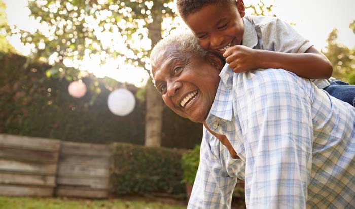 older man playing with child